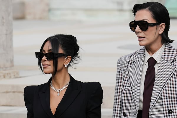 Kim Kardashian, left, accompanied by her mother Kris Jenner leaves the justice palace after testifying, regarding a robbery of millions of dollars in jewels from her Paris hotel room in 2016, in Paris, Tuesday, May 13, 2025. (AP Photo/Aurelien Morissard)