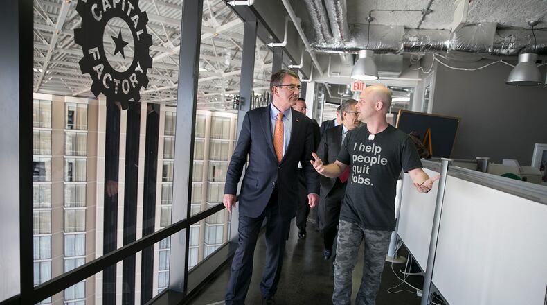 U.S. Secretary of Defense Ash Carter, left, goes on a tour with Josh Baer at Capital Factory on Thursday, March 31, 2016. Carter toured the offices of Capital Factory and listened to pitches from local start ups. DEBORAH CANNON / AMERICAN STATESMAN