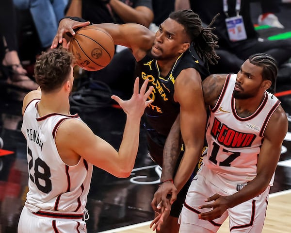 Golden State Warriors' Kevon Looney (5) grabs a rebound in the first half against the Houston Rockets in Game 7 of an NBA basketball first-round playoff series in Houston, Sunday, May 4, 2025. (Carlos Avila Gonzalez/San Francisco Chronicle via AP)