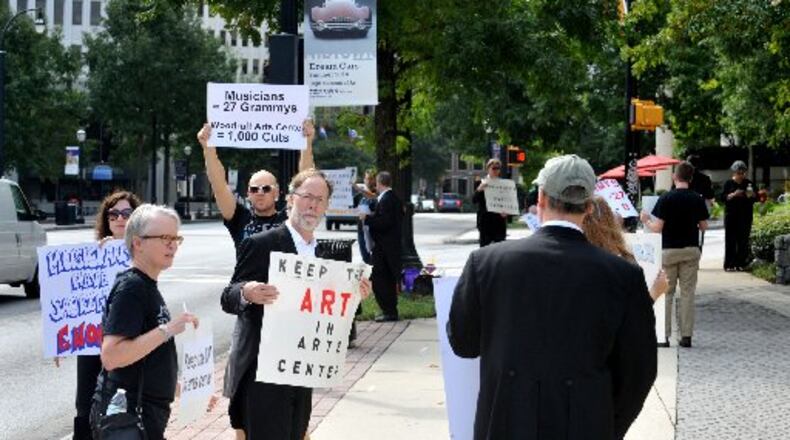 Atlanta Symphony Orchestra musicians and supporters picket in front of the Woodruff Arts Center Monday, September 8, 2014. A Saturday deadline passed without a deal in the Atlanta Symphony Orchestra’s collective bargaining agreement negotiations between management and the musicians. A statement released just past midnight by the Atlanta Symphony Orchestra Players Association said that the musicians believe they are being locked out by ASO management. It was followed momentarily by a statement from ASO management that warned that the 2014-15 season, which is scheduled to open Sept. 25, may be delayed or cancelled. KENT D. JOHNSON / KDJOHNSON@AJC.COM
