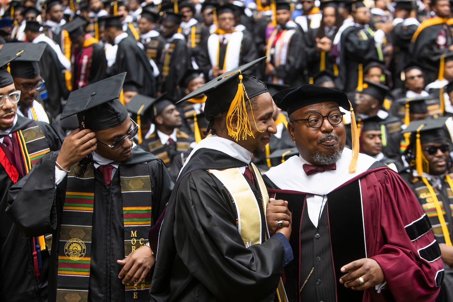 A Morehouse College faculty member prepares graduates to go on stage during the Morehouse College commencement ceremony on Sunday, May 21, 2023, on Century Campus in Atlanta. The graduation marked Morehouse College's 139th commencement program. CHRISTINA MATACOTTA FOR THE ATLANTA JOURNAL-CONSTITUTION