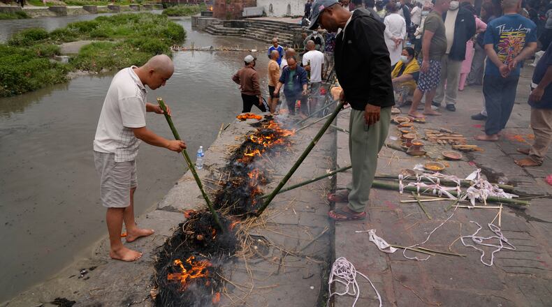 Men perform rituals during symbolic last rites for their relatives who remain missing and are presumed dead following flash floods in Kathmandu, Nepal, Wednesday, Sept. 2, 2026. (AP Photo/Dar Yasin)