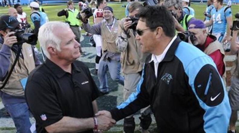 Carolina Panthers head coach Ron Rivera, right, shakes hands with Atlanta Falcons head coach Mike Smith after an NFL football game in Charlotte, N.C., Sunday, Nov. 3, 2013. The Panthers won 34-10. (AP Photo/Mike McCarn)