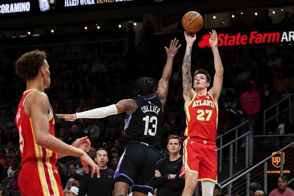 Atlanta Hawks guard Vit Krejci (27) attempts a 3-pointer against Utah Jazz guard Isaiah Collier (13) during the first half of an NBA basketball game, Sunday, April 6, 2025, in Atlanta. (AP Photo/Colin Hubbard)