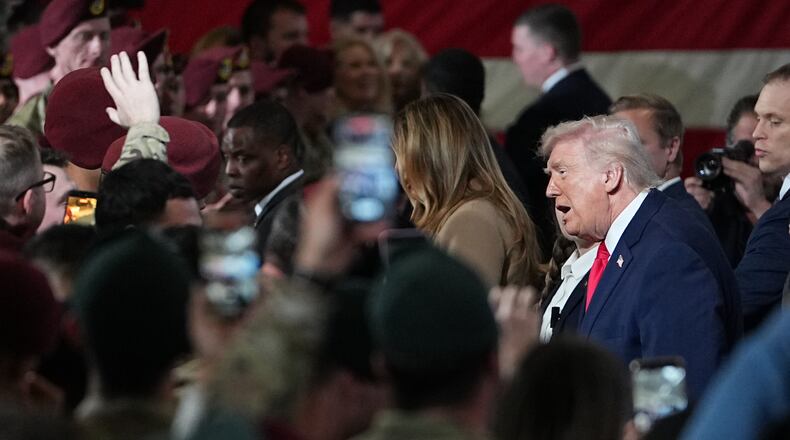 President Donald Trump and first lady Melania Trump walk from the stage after speaking to soldiers and their families at Fort Bragg, N.C., Friday, Feb. 13, 2026. (AP Photo/Matt Rourke)