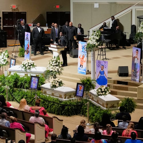 People listen during funeral services for the eight children who were killed during a mass shooting last month, Saturday, May 9, 2026, at the Summer Grove Baptist Church in Shreveport, La. (AP Photo/Gerald Herbert)