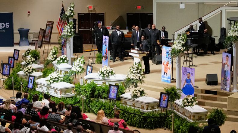 People listen during funeral services for the eight children who were killed during a mass shooting last month, Saturday, May 9, 2026, at the Summer Grove Baptist Church in Shreveport, La. (AP Photo/Gerald Herbert)