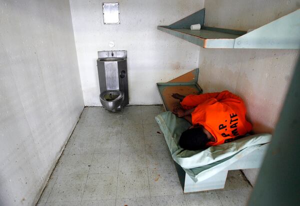 FILE - An inmate sleeps in his cell in the 10th-floor psychiatric section of the Orleans Parish House of Detention on Feb. 26, 2008, in New Orleans. (Michael DeMocker/The Times-Picayune/The New Orleans Advocate via AP, File)