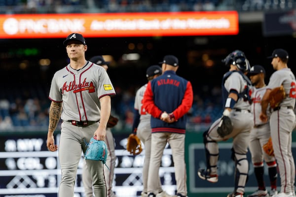 Atlanta Braves pitcher AJ Smith-Shawver, left, walks off the field after being removed from the game by manager Brian Snitker, center, during a baseball game in Washington, Thursday, May 22, 2025. (AP Photo/Terrance Williams)