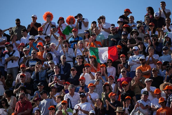 Italian fans cheer for Jannik Sinner during a final tennis match against Carlos Alcaraz of Spain in the Italian Open at the Foro Italico in Rome, Sunday, May 18, 2025. (AP Photo/Alessandra Tarantino)