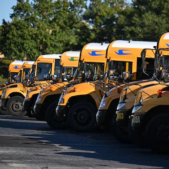 DeKalb County school buses are seen at DeKalb County School District headquarters, Wednesday, October 15, 2025, in Stone Mountain. The school district, and others across metro Atlanta, are canceling weekend activities ahead of this weekend's expected storm. (Hyosub Shin/AJC)