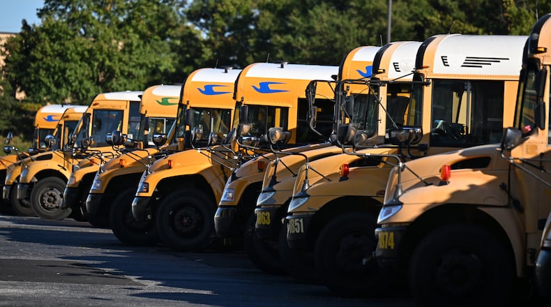 DeKalb County school buses are seen at DeKalb County School District headquarters, Wednesday, October 15, 2025, in Stone Mountain. The school district, and others across metro Atlanta, are canceling weekend activities ahead of this weekend's expected storm. (Hyosub Shin/AJC)