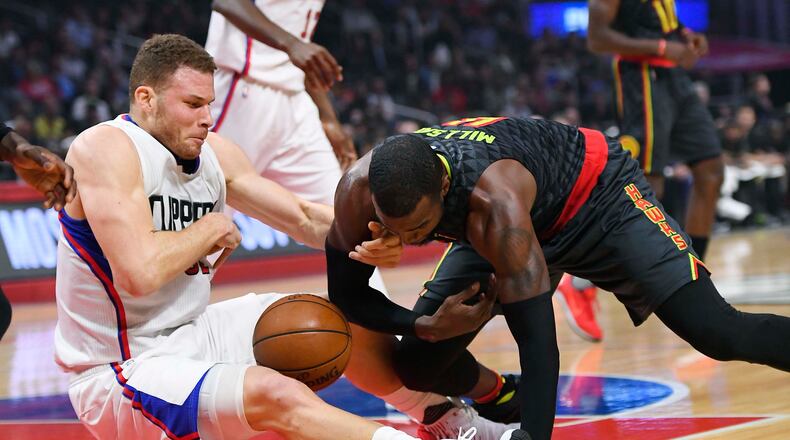 Los Angeles Clippers forward Blake Griffin, left, and Atlanta Hawks forward Paul Millsap scramble for a loose ball during the first half of an NBA basketball game, Wednesday, Feb. 15, 2017, in Los Angeles. (AP Photo/Mark J. Terrill)