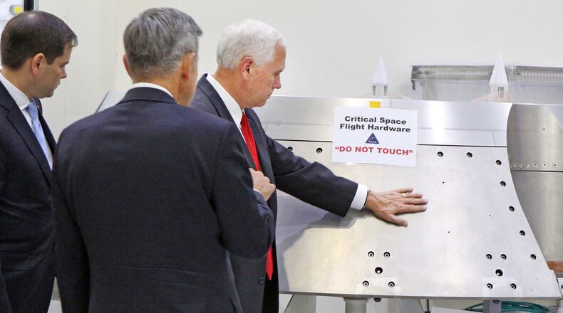 Vice President Mike Pence, right, gets a tour of the Orion spacecraft clean room with Sen. Marco Rubio, R-Fla., by Bob Cabana, director of the Kennedy Space Center, center, at the Kennedy Space Center in Cape Canaveral, Fla., on Thursday, July 6, 2017. Pence is leading a newly revived National Space Council. (Red Huber/Orlando Sentinel via AP)