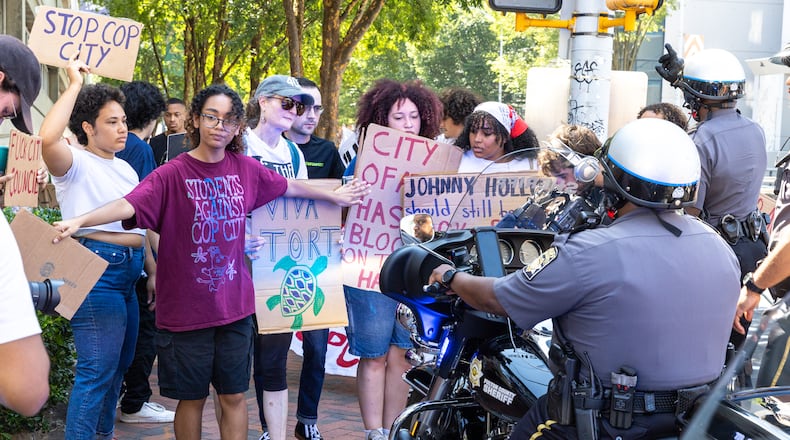 Protestors against Atlanta’s planned public safety training center, known by some as “Cop City,” gather at Fulton County Courthouse in Atlanta on Monday, August 14, 2023, as Fulton prosecutors present a their election interference case against former President Donald Trump and others to a grand. (Arvin Temkar / arvin.temkar@ajc.com)