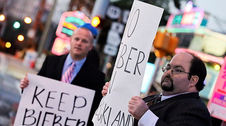 Feb. 24, 2014 Atlanta: The Bieber "protest" Monday morning turned out to be a joke event staged by the Regular Guys morning show. Allegedly, radio interns dressed in suits and tie paraded around with signs and gave sober quotes like "We just don't think it's good for our neighborhood." The protesters that gathered on Roswell Road and Blackland Road in Buckhead Monday, Feb, 24, 2014 to protest against pop star, Justin Bieber moving into a Buckhead mansion was part of a local radio show prank. The handful of "protesters" at Monday’s predawn event were allegedly radio interns. The Bieber "protest" turned out to be a joke event staged by the Regular Guys morning show. Alledgedly radio interns dressed in suits and tie paraded around with signs and gave sober quotes to the media like "We just don't think it's good for our neighborhood." This too shall pass."Buckhead Coalition president Sam Massell has been fielding phone calls about a move to protest pop star Justin Bieber moving into the neighborhood. "This so-called Buckhead Neighborhood Coalition is something we're not aware of," he said of the group whose Facebook page recently appeared "We've never heard of them." Massell got a good chuckle over the "controversy." "We've had calls from CNN, from the UK, from the daily newspaper in Canada," he said. "It's made international news. There are so many other things more important to concentrate on. JOHN SPINK/JSPINK@AJC.COM