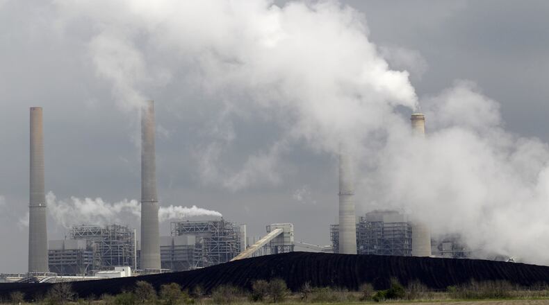 Exhaust rises from smokestacks in front of piles of coal in Thompsons, Texas. In Georgia, state officials recently brought an end to a 12-year effort to build a new coal plant in Washington County. Plant Washington was believed to have been the last new coal plant proposed for construction in the nation. AP PHOTO / DAVID J. PHILLIP, FILE