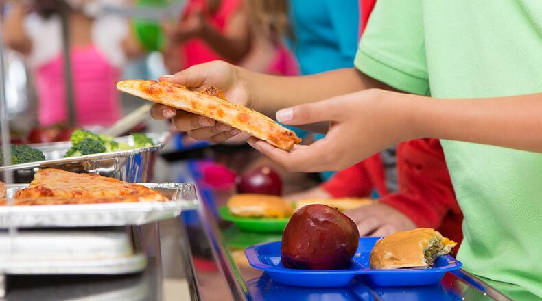Stock photo of a school cafeteria.