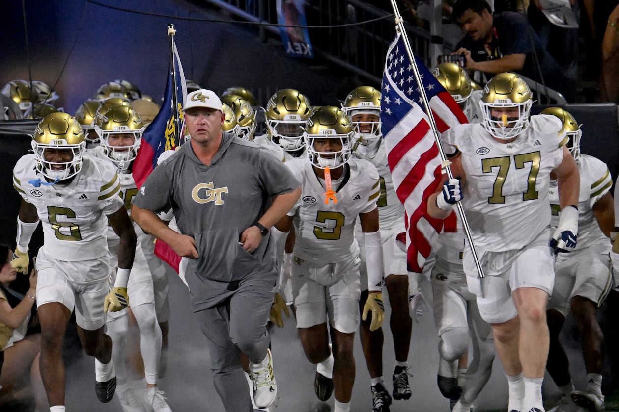 Georgia Tech head coach Brent Key runs onto the field with his players before the final regular-season home game against Pittsburgh at Bobby Dodd Stadium on Saturday, Nov. 22, 2025, in Atlanta. (Hyosub Shin/AJC)