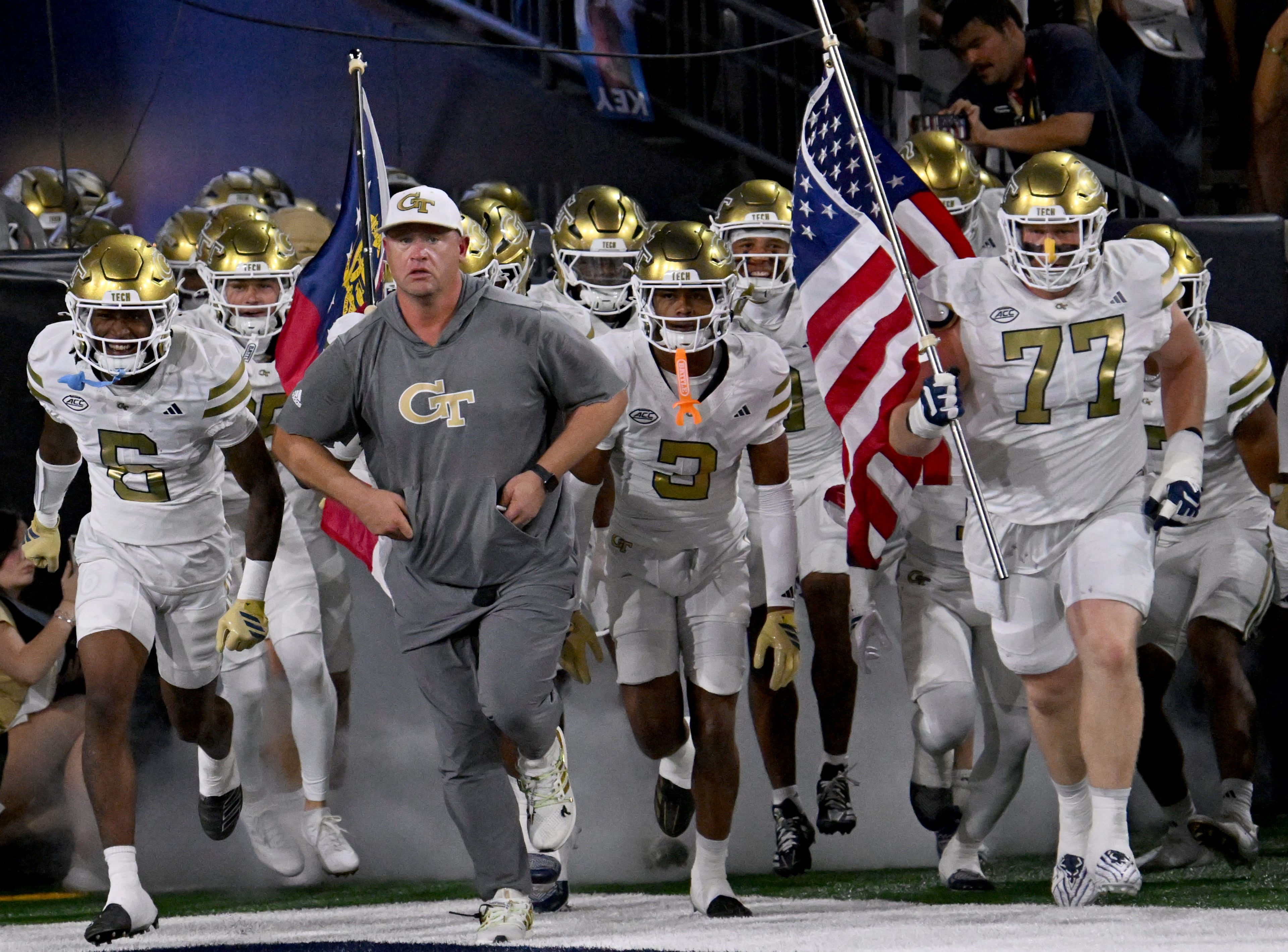Georgia Tech head coach Brent Key and players run onto the field before the final regular-season home game against Pittsburgh at Bobby Dodd Stadium, Saturday, November 22, 2025 in Atlanta. (Hyosub Shin / AJC)