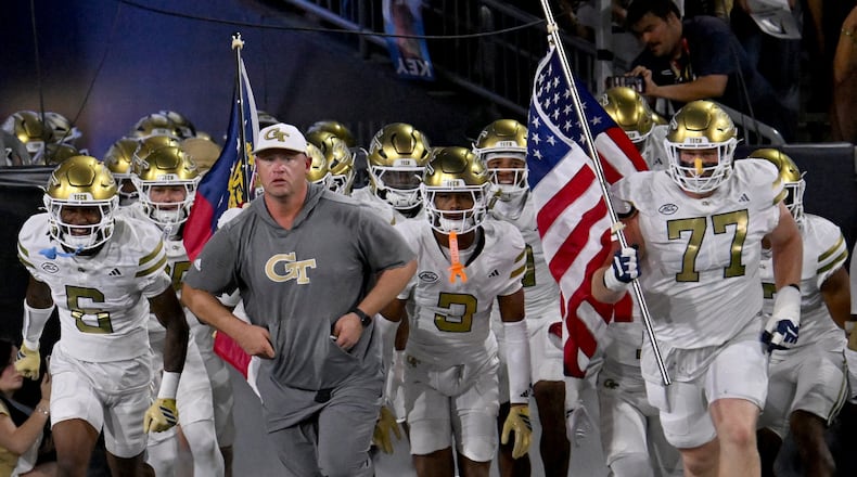 Georgia Tech head coach Brent Key runs onto the field with his players before the final regular-season home game against Pittsburgh at Bobby Dodd Stadium on Saturday, Nov. 22, 2025, in Atlanta. (Hyosub Shin/AJC)