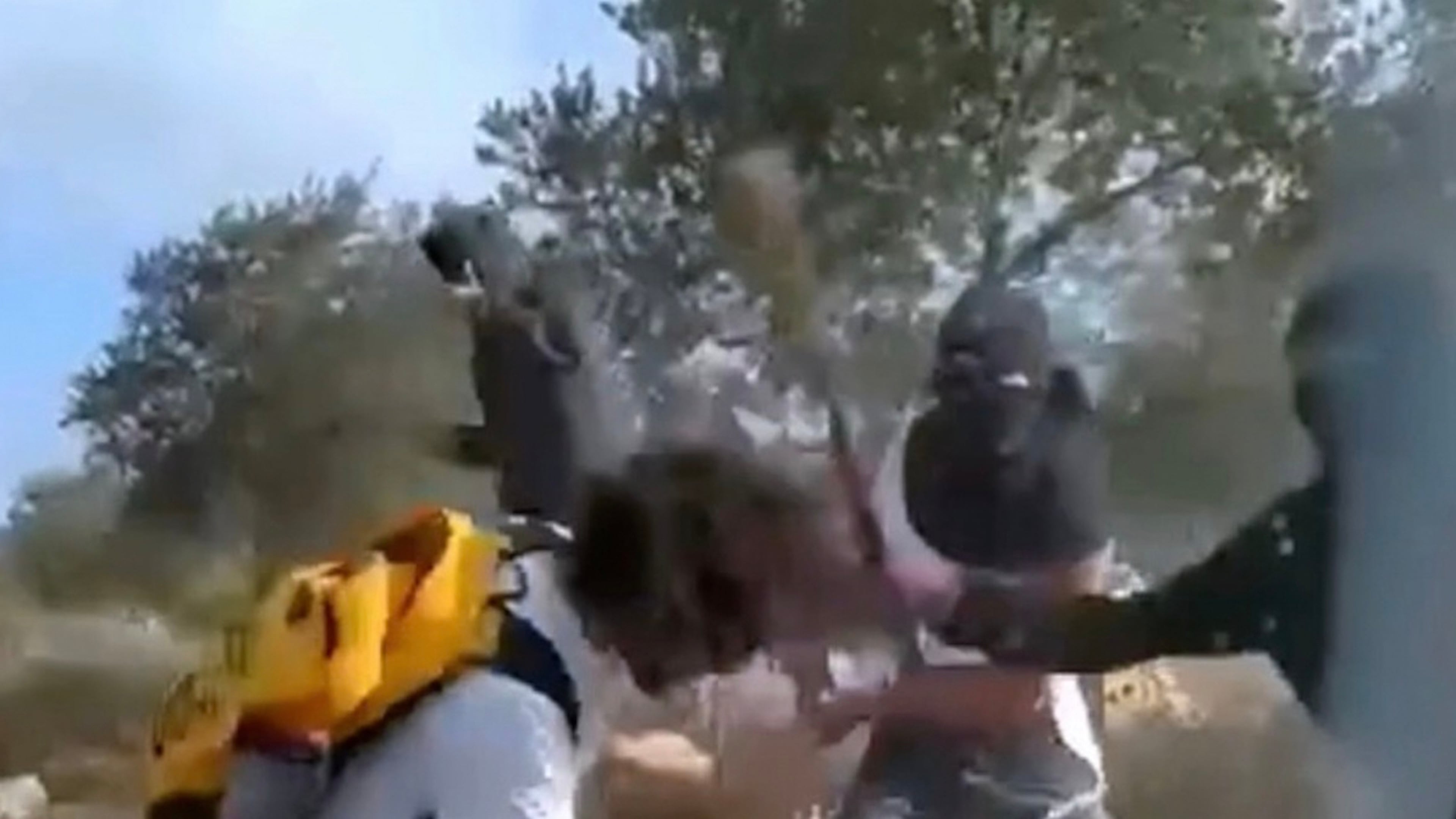 This Oct. 19, 2025, image taken from video shows what appear to be masked settlers beating activists and Palestinian farmers in Turmus Ayya, West Bank. (AP Photo)