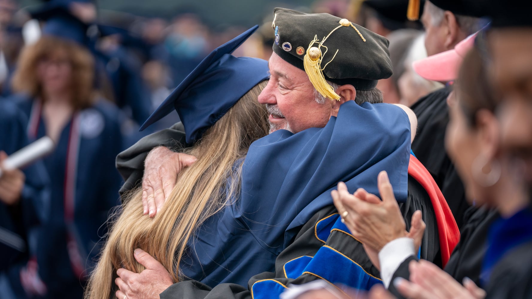 A graduate hugs longtime professor and mentor Dr. Christopher Hall after graduating from at Berry College on Saturday, May 9, 2026. Berry College is recognized nationally and is located on a campus encompassing more than 27,000 acres near Rome, Ga. (Daniel Whiting/Berry College)