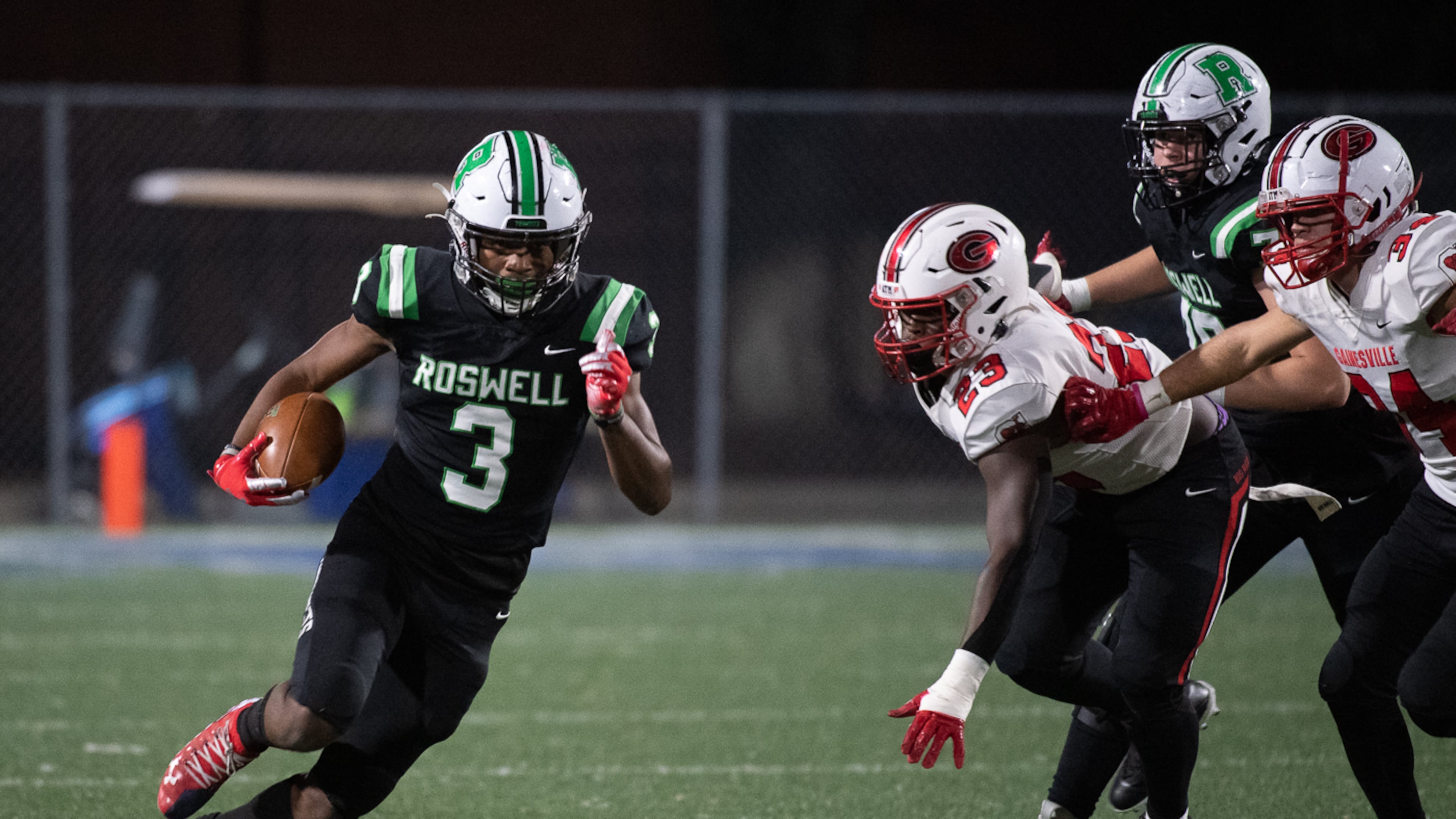 Roswell’s Nykahi Davenport looks for yardage against the Gainesville defense during a 2022 state semifinal game. Gainesville, fresh off a program-building upset of Milton, can win Region 7-5A against fellow unbeaten Roswell this Friday. (Jamie Spaar for the AJC)