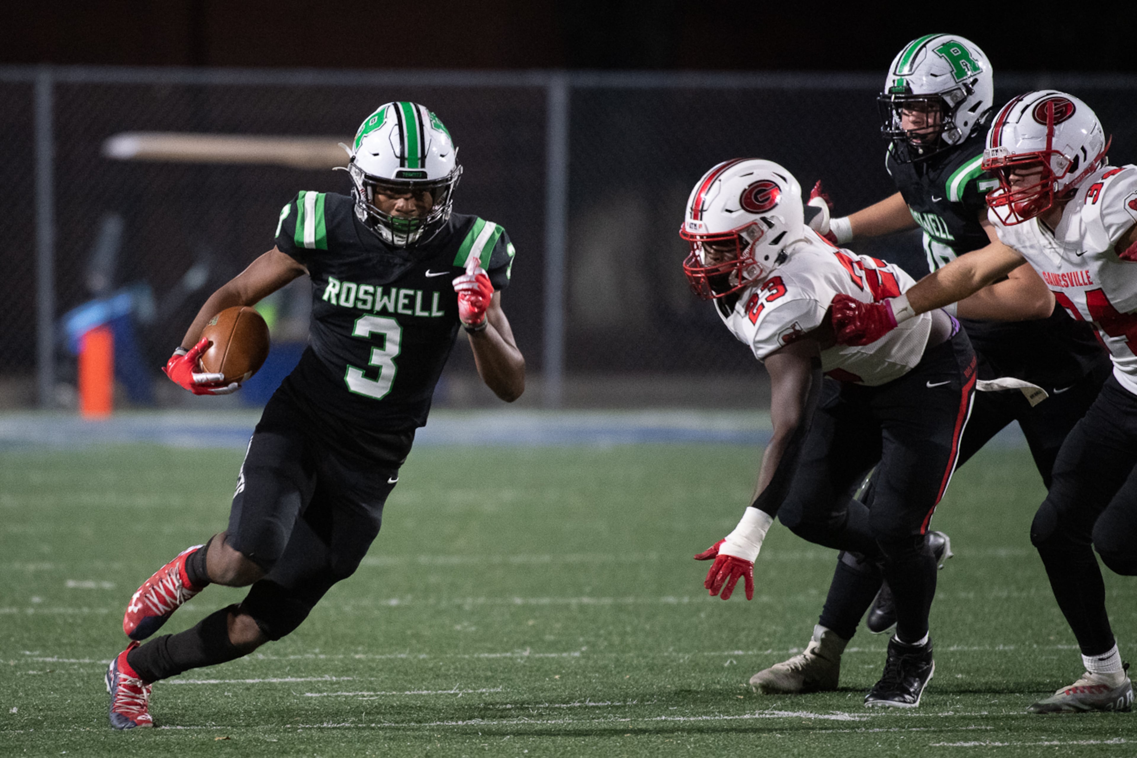 Roswell's Nykahi Davenport looks for yardage against the Gainesville defense during Friday's state semifinal game.