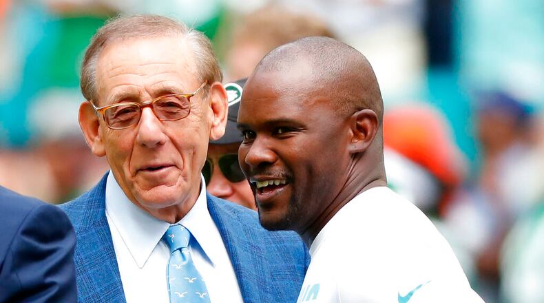 Miami Dolphins head coach Brian Flores talks to Miami Dolphins owner Stephen M. Ross during practice before an NFL football game against the New York Jets, Sunday, Nov. 3, 2019, in Miami Gardens, Fla. (AP Photo/Wilfredo Lee, File)
