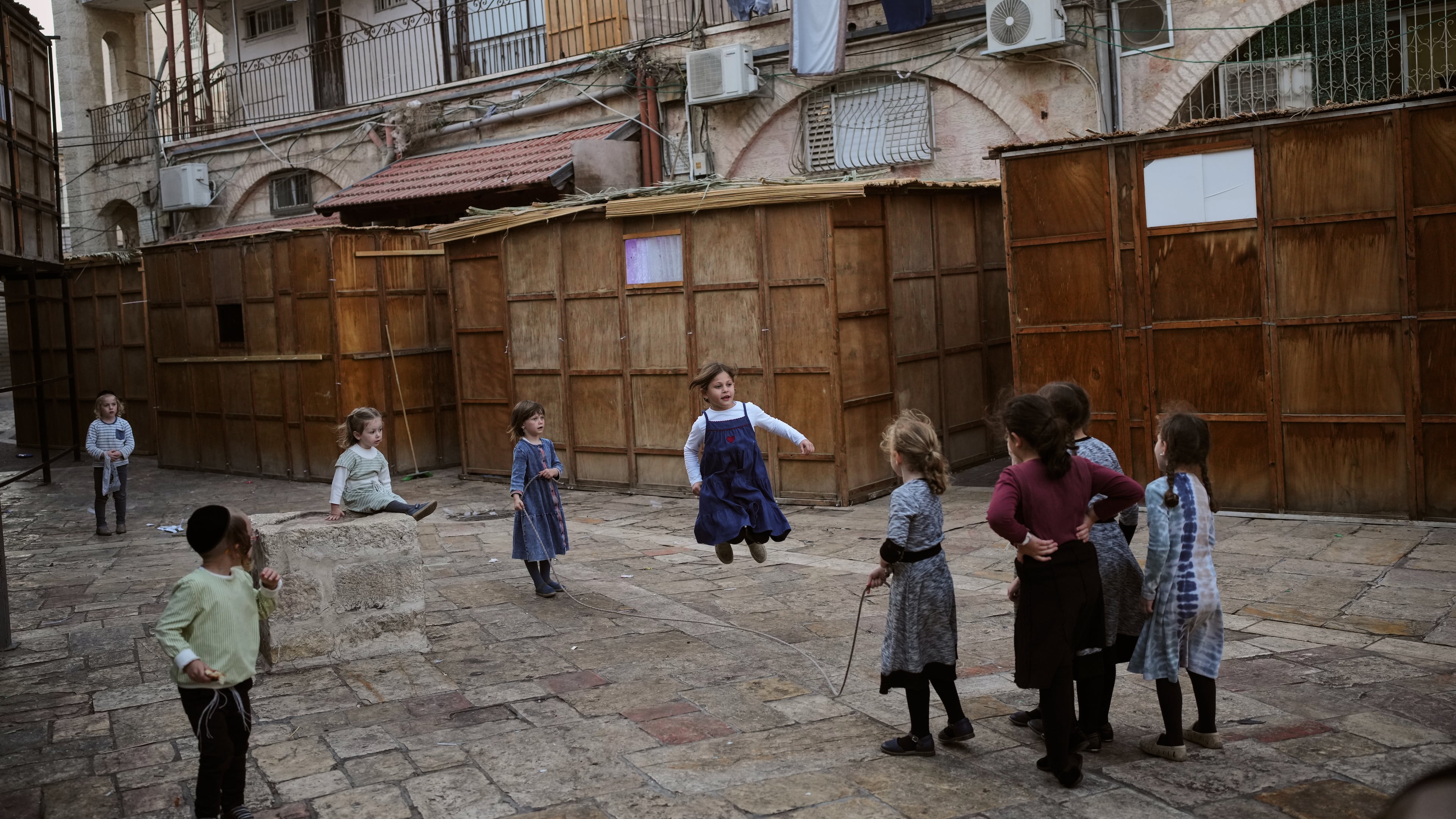 Ultra-Orthodox Jewish children play next to Sukkahs, a temporary structures built for the upcoming Jewish holiday of Sukkot in the Orthodox Jewish neighborhood of Mea Shearim in Jerusalem, Sunday, Oct. 5, 2025. (AP Photo/Ohad Zwigenberg)