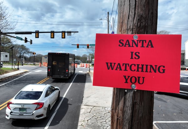 Yet another "SANTA IS WATCHING YOU" sign was spotted on a pole near the Amoco Station at the corners of Boulevard SE and Custer Avenue SE. (Hyosub Shin/AJC)