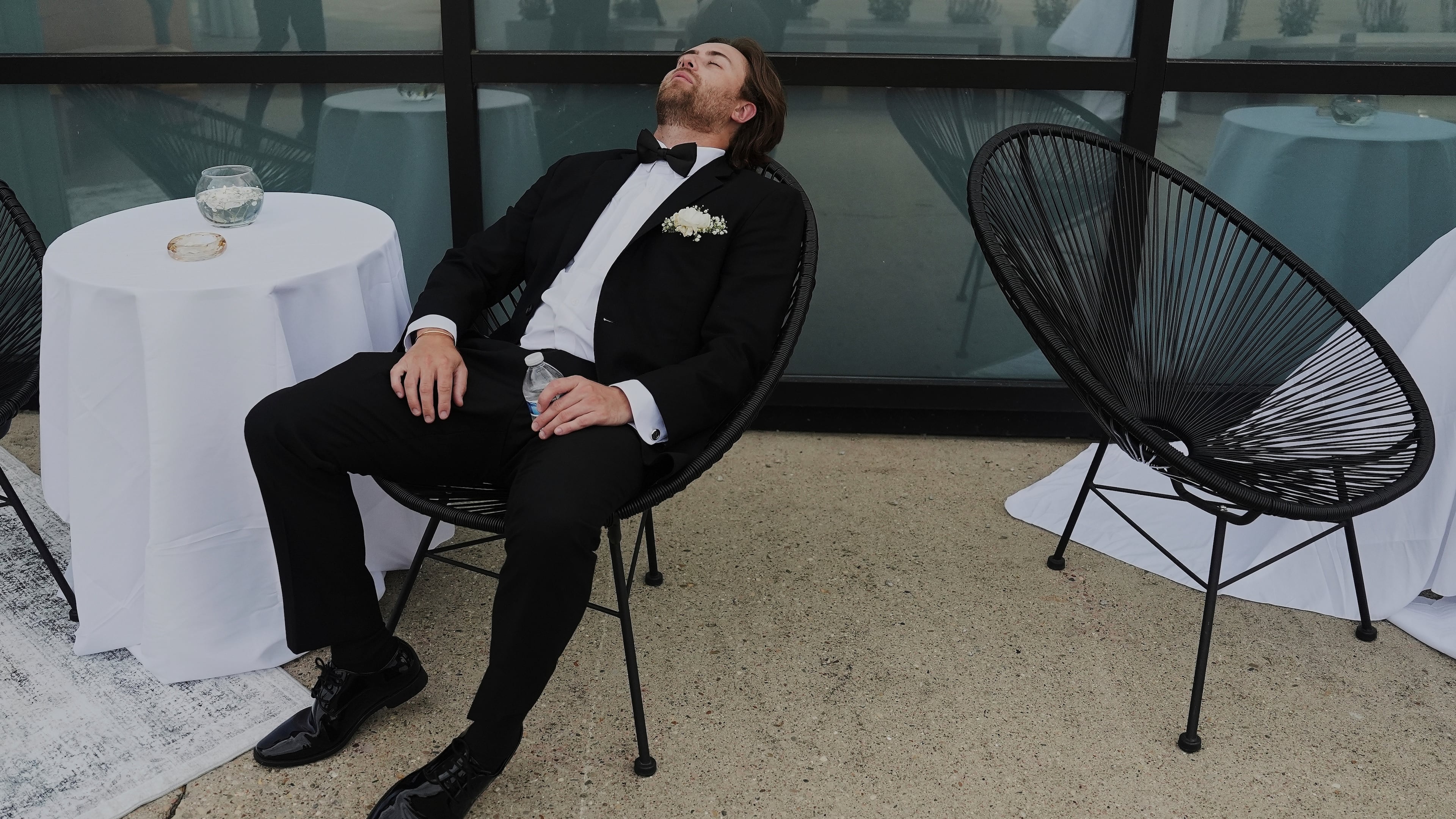 FILE - A Groomsman takes a break after finishing bridal party photos at a wedding on Saturday, Aug. 23, 2025, in Newtown, Ohio. (AP Photo/Joshua A. Bickel, File)