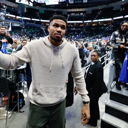 Milwaukee Bucks forward Giannis Antetokounmpo, center, walks off the court after an NBA basketball game against the Brooklyn Nets, Friday, April 10, 2026, in Milwaukee. (AP Photo/Jeffrey Phelps)