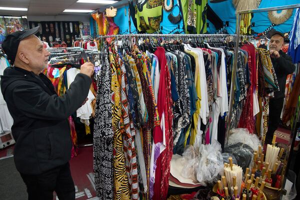 Business owner Sam Sham, originally from India, comments on upcoming import tariffs for the African and Indian-made clothes he sells at his "O.K. Mike" resort wear store in the Fashion District in Los Angeles, Thursday, April 3, 2025. (AP Photo/Damian Dovarganes)