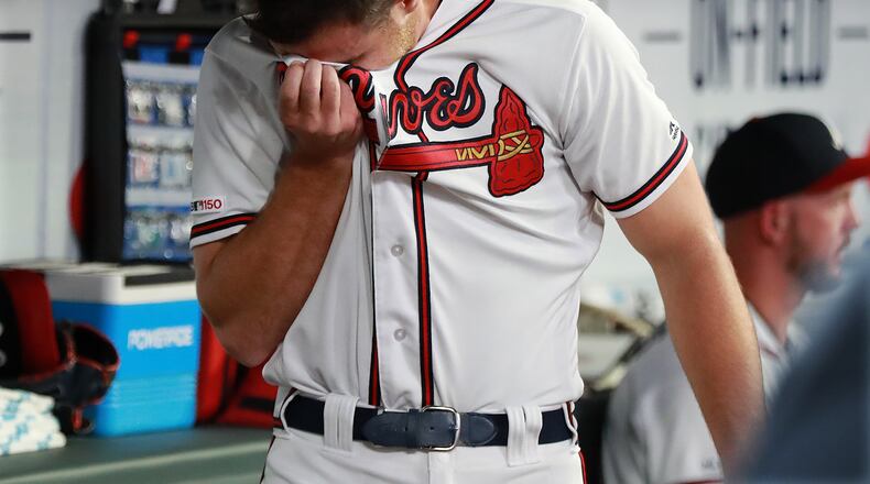 Braves pitcher Jesse Biddle reacts in the dugout after loading the bases and walking in the eventual winning run during the 10th inning.  Curtis Compton/ccompton@ajc.com