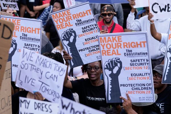 Activists chant slogans as they hold placards during the women's protest and hand over of a petition demanding that gender-based violence and femicide be declared a national disaster, at the Union Buildings in Pretoria, South Africa, Friday, April 11, 2025. (AP Photo/Themba Hadebe)