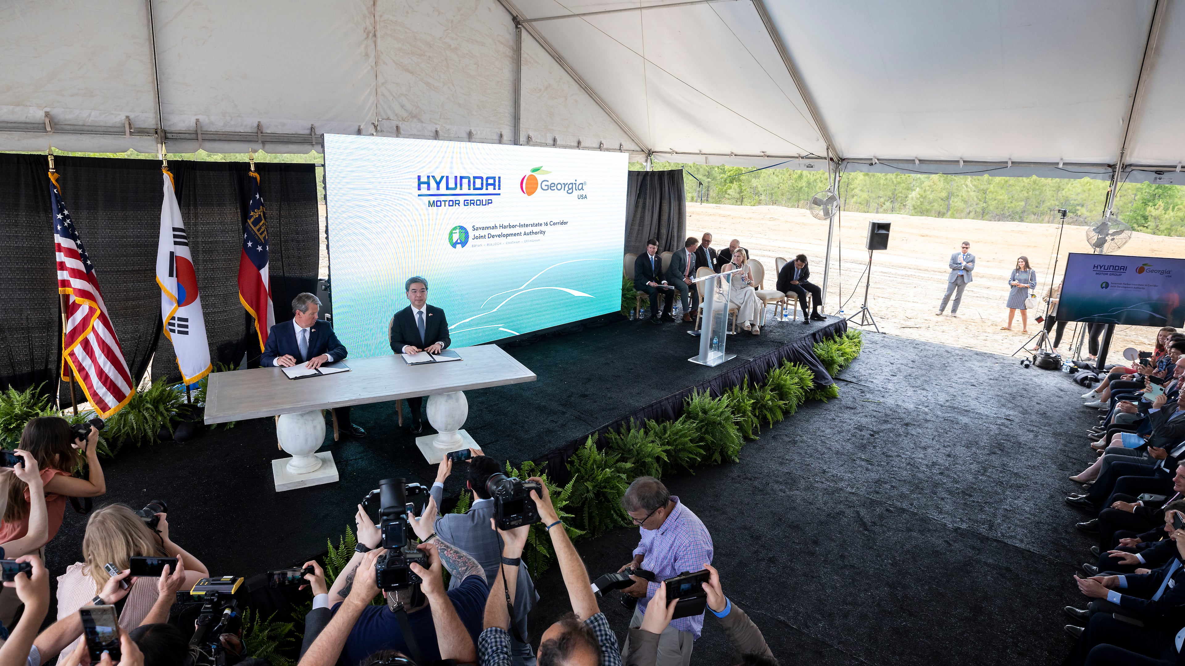 In 2020, Gov. Brian Kemp, (at table, left) and Jaehoon Chang, then the president and CEO of Hyundai Motor Group, announced that the South Korean automotive giant was building an electric vehicle plant in Ellabell. (Stephen B. Morton for the AJC)