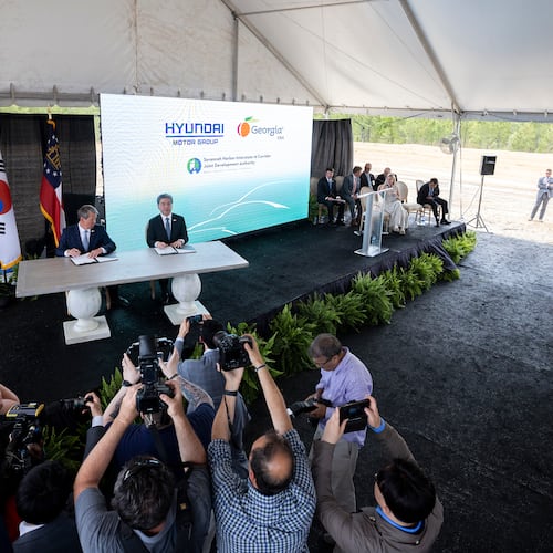 In 2020, Gov. Brian Kemp, (at table, left) and Jaehoon Chang, then the president and CEO of Hyundai Motor Group, announced that the South Korean automotive giant was building an electric vehicle plant in Ellabell. (Stephen B. Morton for the AJC)