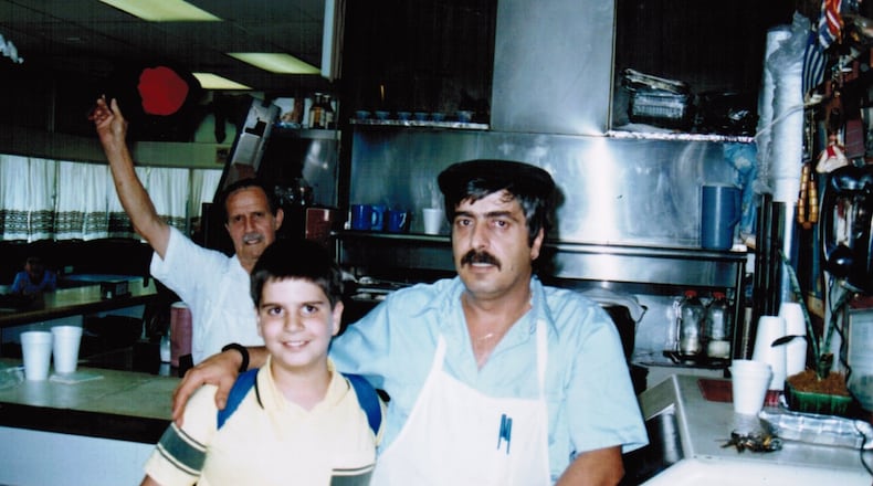 Grecian Gyro opened its first location in Hapeville nearly 40 years ago. Here George Koulouris (left) with his father Nick Koulouris. George and his brother Pano Koulouris currently run the family business and its seven restaurants. Two locations of the restaurant opened on Thanksgiving Day, providing free meals to about 200 people in the giving-back spirit that their father instilled in them. Courtesy of George Koulouris