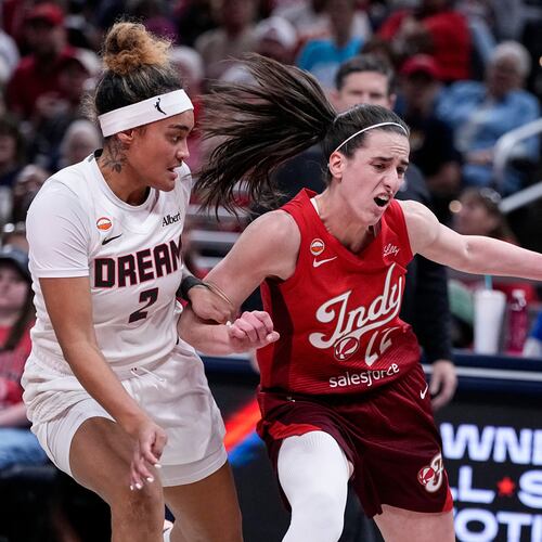 Indiana Fever guard Caitlin Clark (22) drives on Atlanta Dream guard Te-Hina Paopao (2) in the first half of a WNBA basketball game in Indianapolis, Thursday, June 18, 2026. (AP Photo/Michael Conroy)