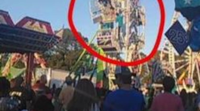 A 13-year-old boy dangles from the Zipper ride at the Coosa Valley Fair in Rome. (Credit: Rome News-Tribune)