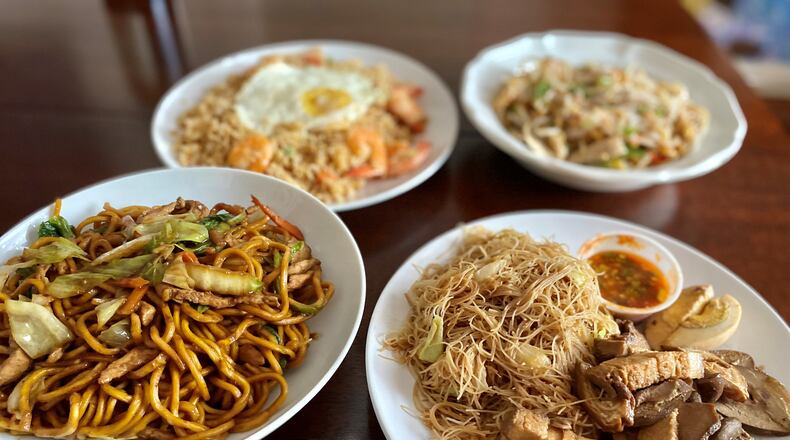 Among the tantalizing dishes at Two Fish Myanmar are stir-fried noodles with beef (left) and grilled pork with noodles; in the background are shrimp fried rice (left) and meeshay (noodles with chicken and gravy). Wendell Brock for The Atlanta Journal-Constitution