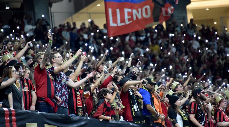 October 24, 2019 Atlanta - Atlanta United fans cheer for their team as they hold lights in the second half during Eastern Conference semifinals of MLS playoffs at Mercedes-Benz Stadium on Thursday, October 24, 2019. Atlanta United won 2-0 over the Philadelphia Union. (Hyosub Shin / Hyosub.Shin@ajc.com)