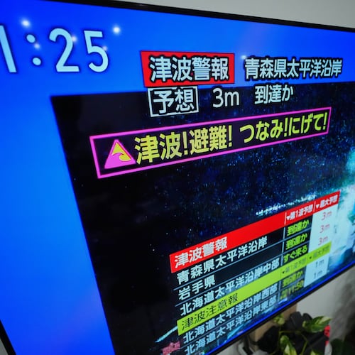 A tsunami warning is displayed on a television in Yokohama, near Tokyo, Monday, Dec. 8, 2025, after a strong earthquake hits off Japanese northern coast, tsunami alert issued. (AP Photo/Eugene Hoshiko)
