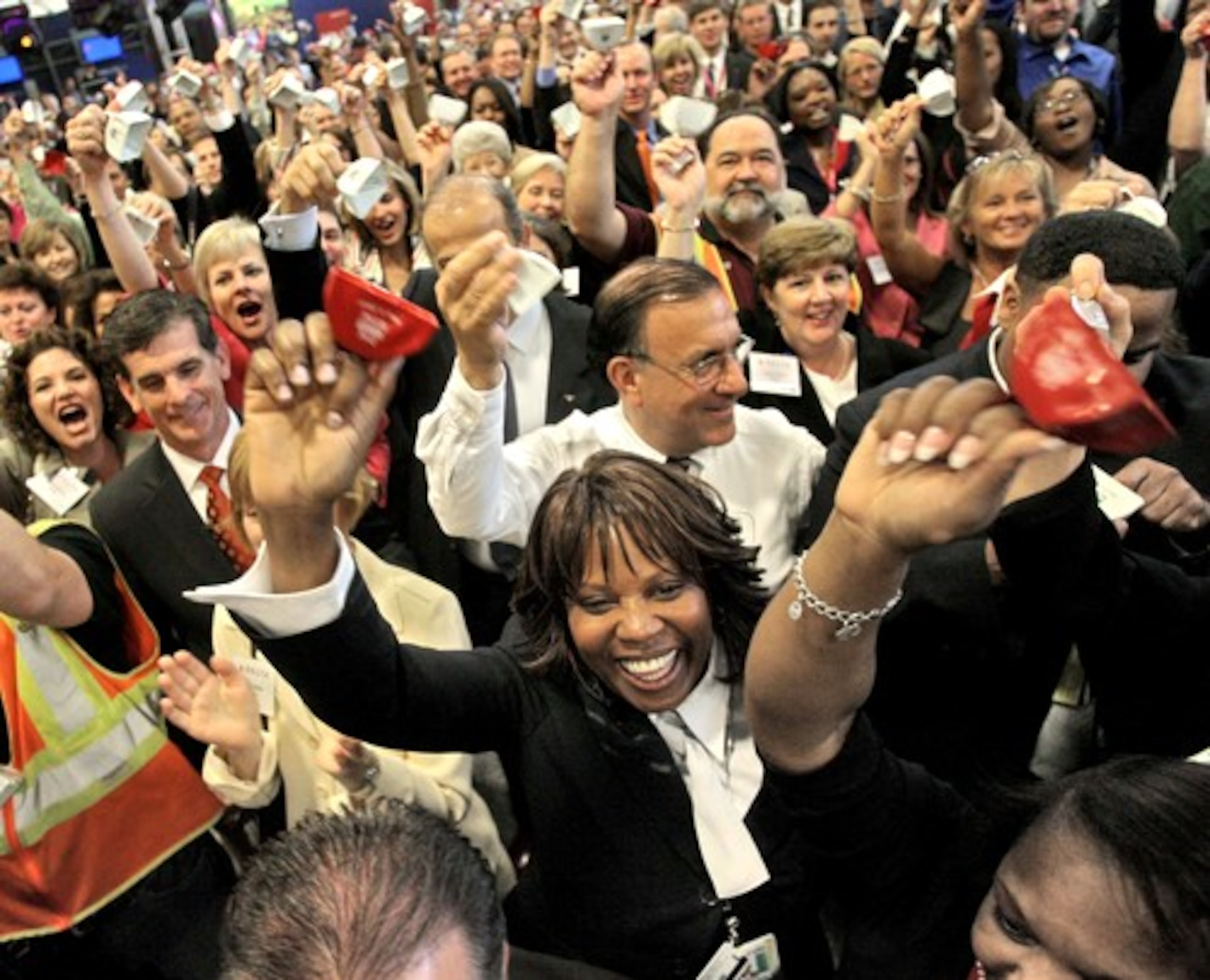 Delta employee Wolina Thrower is joined by c0-workers as Delta executives symbolically rang the New York Stock Exchange bell after Delta shares began regular trading when it emerged from bankruptcy. (AJC file)