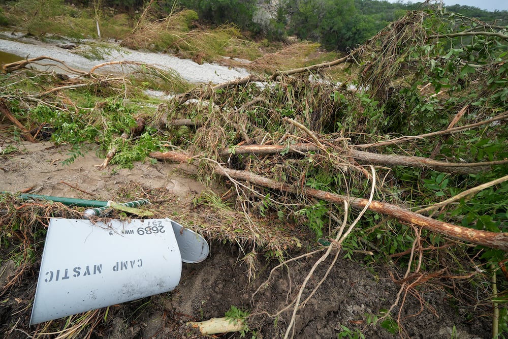 A toppled Camp Mystic mailbox near the entrance to the establishment along the banks of the Guadalupe River after a flash flood swept through the area on Saturday in Hunt, Texas.