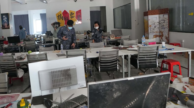 Thai soldiers inspect a work station at the scam compound in O'Smach, Cambodia, Tuesday, April 7, 2026. (AP Photo/Sakchai Lalit)