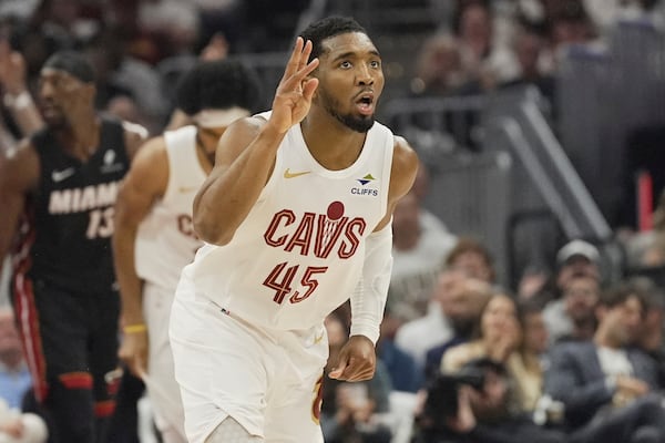 Cleveland Cavaliers guard Donovan Mitchell (45) gestures after a three point basket in the first half in Game 2 of an NBA first-round playoff series against the Miami Heat, Wednesday, April 23, 2025, in Cleveland. (AP Photo/Sue Ogrocki)