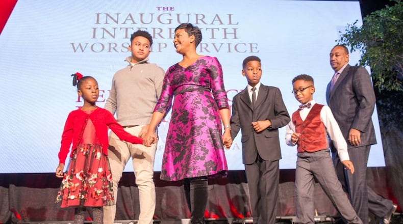 Atlanta mayor elect Keisha Lance-Bottoms and her family take the stage for prayer during the Atlanta inaugural interfaith worship service held at Impact Church in East Point, Tuesday. ALYSSA POINTER/ALYSSA.POINTER@AJC.COM